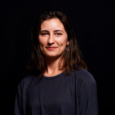 Image of Rachel Clark, a white woman smiling with a black background.