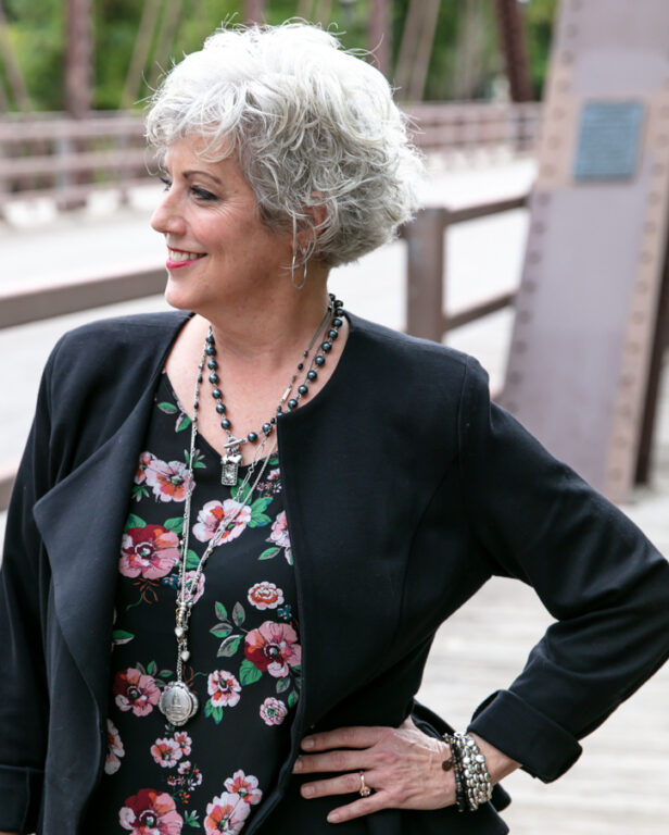 White woman, Kim Hansen, in profile on a bridge.
