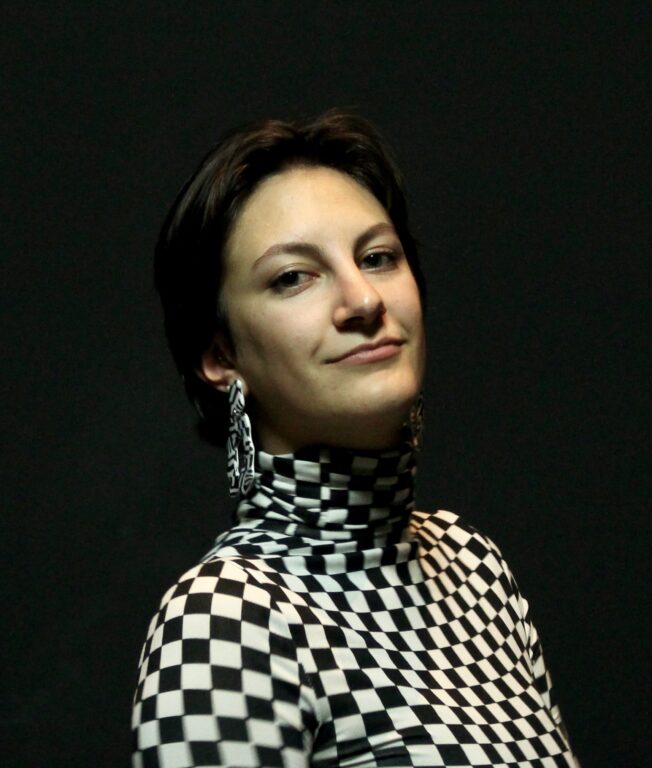 White woman Eliana Durnbaugh in a black and white checkered shirt